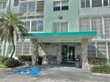 Building entrance featuring stone accents, covered entry, and handicap access at 100 Waverly Way # 302, Clearwater, FL 33756