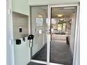 Close up of the building's entrance and inner lobby with information and door at 100 Waverly Way # 302, Clearwater, FL 33756