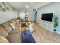 Relaxing living room with tile floors, large sectional sofa, and modern accents at 12361 114Th St, Largo, FL 33778