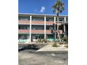 The condominium building has multiple stories with brick accents, offering covered parking at 4300 58Th N St # 1909, Kenneth City, FL 33709