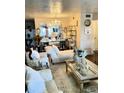 This opulent living room features decorative mirrors, shelves and chandelier at 4300 58Th N St # 1909, Kenneth City, FL 33709