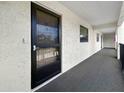 View of the hallway, with a neutral carpet leading to other front doors at 11485 Oakhurst Rd # A301, Largo, FL 33774