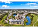 Scenic aerial view of community with lake, golf course, and multiple residential buildings at 960 Starkey Rd # 10301, Largo, FL 33771