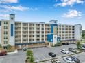 Exterior of condo building featuring a parking area, manicured landscaping, and a modern design at 960 Starkey Rd # 10301, Largo, FL 33771