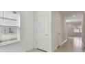 Bright hallway with tiled floors and fresh white paint and natural light at 1165 Kistna Dr, Zephyrhills, FL 33540