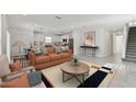 Bright, open-concept living room with an eat-in kitchen, featuring modern decor and plenty of natural light at 1165 Kistna Dr, Zephyrhills, FL 33540