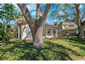 Beautiful home exterior surrounded by mature trees and lush greenery, creating a serene setting at 1370 Brightwaters Ne Blvd, St Petersburg, FL 33704