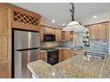 Bright kitchen with stainless steel appliances, granite countertops, and stylish pendant lighting at 3151 Landmark Dr # 123, Clearwater, FL 33761
