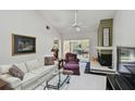 Cozy living room with white sofa, fireplace, and access to the lanai at 3151 Landmark Dr # 123, Clearwater, FL 33761
