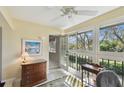 Bright sunroom featuring large windows with view, tile flooring, and neutral walls at 3151 Landmark Dr # 123, Clearwater, FL 33761