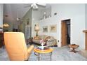 Living room with vintage furniture, neutral walls, and vaulted ceilings at 5565 Salem Square N Dr, Palm Harbor, FL 34685
