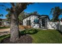 Charming home with a well-manicured lawn, stone columned entryway, and inviting wooden deck at 2835 Freemont S Ter, St Petersburg, FL 33712