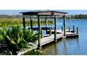 Well-maintained boat dock with covered boat lift, perfect for enjoying waterfront activities at 10532 94Th Pl, Seminole, FL 33772