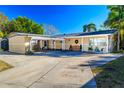 Charming single-story home with a porte-cochere and well-maintained landscaping offering great curb appeal at 10532 94Th Pl, Seminole, FL 33772