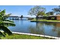 Stunning waterfront view featuring a boat dock, gazebo, and lush green landscaping at 10532 94Th Pl, Seminole, FL 33772