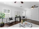 Stylish living room featuring plantation shutters, hardwood floors, and contemporary furnishings at 156 29Th N Ave, St Petersburg, FL 33704