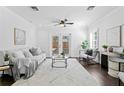 Bright living room with neutral decor, hardwood floors, and French doors to outdoor space at 156 29Th N Ave, St Petersburg, FL 33704