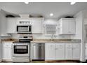 View of the kitchen featuring stainless steel appliances and granite countertops at 206 S Port Royal Ln, Apollo Beach, FL 33572