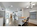 Charming kitchen features an island with seating, chandelier and stainless steel appliances at 206 S Port Royal Ln, Apollo Beach, FL 33572