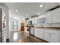 Bright kitchen with stainless steel appliances, granite countertops and wood-look flooring at 206 S Port Royal Ln, Apollo Beach, FL 33572