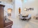 Bright dining room with soaring ceilings, elegant chandelier, and ample seating for dinner guests at 6467 Willowshire Way, Bradenton, FL 34212