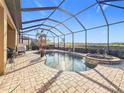 A screened-in patio features a lovely private pool and spa, perfect for relaxation and entertaining at 6467 Willowshire Way, Bradenton, FL 34212