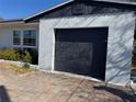 Attached garage with an updated door and adjacent windows at 8075 Gulf Blvd, St Pete Beach, FL 33706