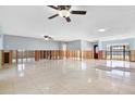 Spacious room with tile flooring, ceiling fans, and natural light ready for renovation at 8421 Flagstone Dr, Tampa, FL 33615
