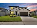 Charming two-story home featuring a well-manicured lawn and a two car garage with a neutral color scheme at 13526 Palmera Vista Dr, Riverview, FL 33579