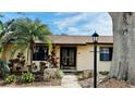 Charming home featuring a well-manicured front yard, complemented by a beautiful double-door entrance at 1670 Monterey Dr, Clearwater, FL 33756