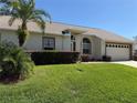 Single story home with manicured lawn, landscaping, and a two-car garage at 9337 Zamora Dr, New Port Richey, FL 34655
