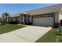 Lovely single-story home with a paved driveway, lush lawn, and attached two-car garage at 9337 Zamora Dr, New Port Richey, FL 34655