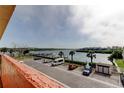 A spacious waterfront parking lot with ample parking and tropical landscaping at 19701 Gulf Blvd # 328, Indian Shores, FL 33785