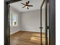 Bright room showcasing hardwood flooring, ceiling fan, and French doors at 2436 Jacobs St, Port Charlotte, FL 33953