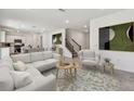Bright and airy living room featuring neutral tones, modern decor and an open-concept floor plan at 36424 Sespe Creek Ct, Zephyrhills, FL 33540