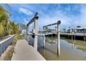Outdoor dock and boat lift with the canal and lush greenery at 6538 Simone Shores Cir, Apollo Beach, FL 33572