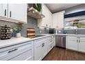 Modern kitchen featuring sleek white cabinets, stainless steel appliances, and quartz countertops at 5292 Kernwood Ct, Palm Harbor, FL 34685