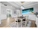 Formal dining room boasts elegant wainscoting, modern chandelier, and a large painting at 5749 Cheech Gln, Bradenton, FL 34211