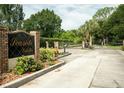 Elegant gated entrance to Seaside Estates featuring lush landscaping and secure access at 102 Brent Cir, Oldsmar, FL 34677