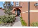 Charming home featuring a beautiful front door framed by an arched entryway and manicured landscaping at 11804 Bluegrass Field Ct, Riverview, FL 33579