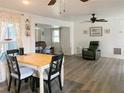 Bright living room featuring wood-look floors, a ceiling fan, and comfortable seating area at 114 W Saint Johns Way, Apollo Beach, FL 33572