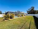 Large backyard with a screened-in pool area, perfect for outdoor entertaining and relaxation at 13290 75Th Ave, Seminole, FL 33776
