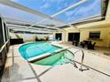 Inviting screened-in pool area with comfortable seating and a relaxing spa at 13290 75Th Ave, Seminole, FL 33776