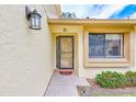 Close-up of the front door with a decorative light fixture, showing the house number and landscaped entrance at 2546 Oakleaf Ln # 35D, Clearwater, FL 33763