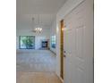 Bright living room features a fireplace and sliding doors to the lanai at 2567 Bentley Dr, Palm Harbor, FL 34684