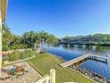 A waterfront backyard featuring a fire pit and private dock on the river at 2902 N Shoreview Pl, Tampa, FL 33602