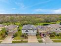 Beautiful two-story home with a two-car garage, lush landscaping, and a lovely exterior paint scheme at 5045 Ivory Stone Dr, Wimauma, FL 33598