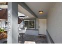 Close-up of the covered front porch and entrance showcasing the house number, lighting, and stylish door at 3087 Duane Ave, Oldsmar, FL 34677