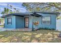 Charming home featuring a front porch, freshly painted exterior, and well-manicured lawn at 4412 W Pearl Ave, Tampa, FL 33611