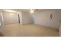 Spacious living room with tile flooring, modern ceiling fan and chandelier at 4725 Michael Ct # 131, Tampa, FL 33614
